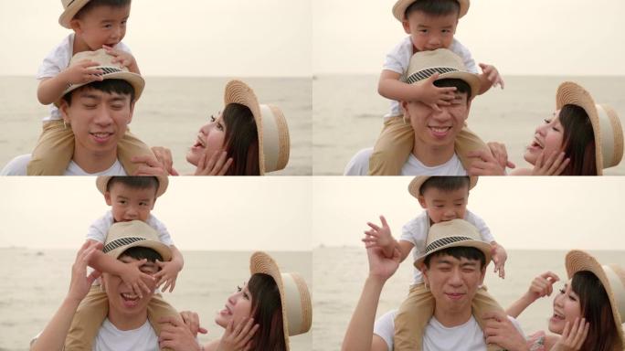 快乐的亚洲家庭在海滩上玩得开心