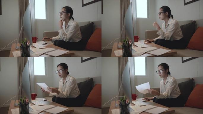 在现代家庭的桌面上工作的亚洲女性的场景