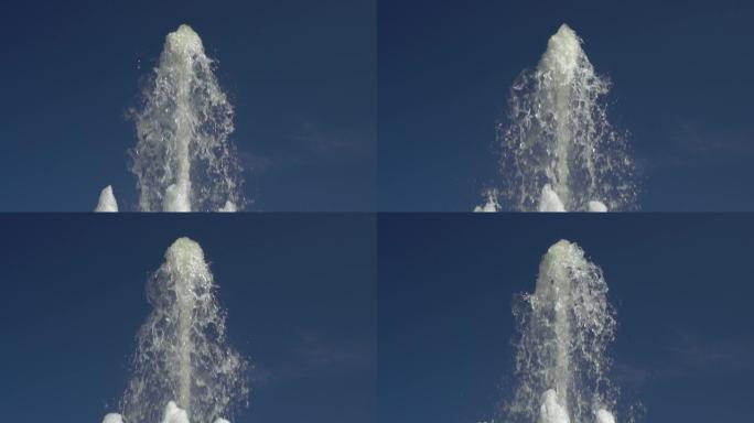 高高的喷泉喷流在蔚蓝的夏日天空中升起。