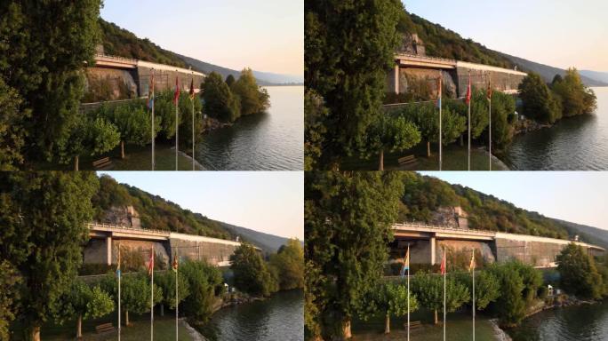 日出时在比尔湖上环绕瑞士国旗的鸟瞰图