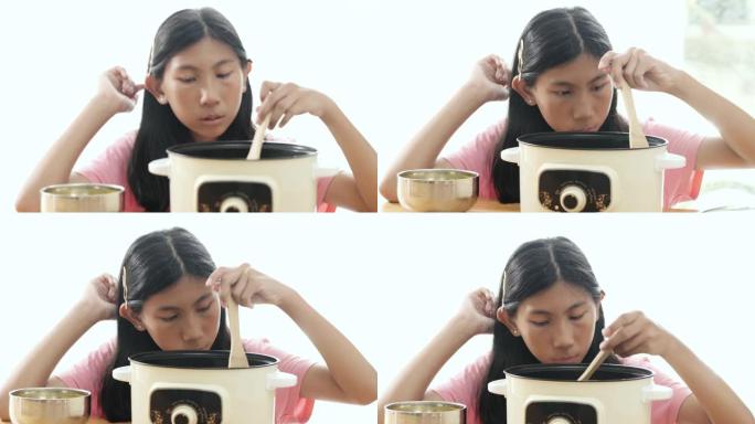 亚洲女孩在锅里搅拌食物，生活方式概念。