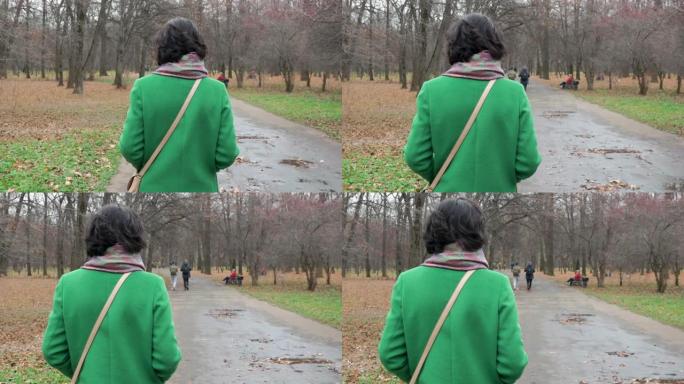 秋天的一天，一个女人走公园人行道，人们从后面走慢动作
