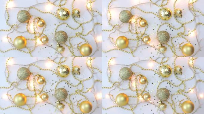 白色背景上的圣诞金色装饰和闪烁的花环上撒满星星。从上方观看。固定。概念，圣诞节和新年庆祝活动