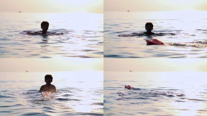 儿童在日落期间在湖水中游泳，儿童躲闪控制的遥控船