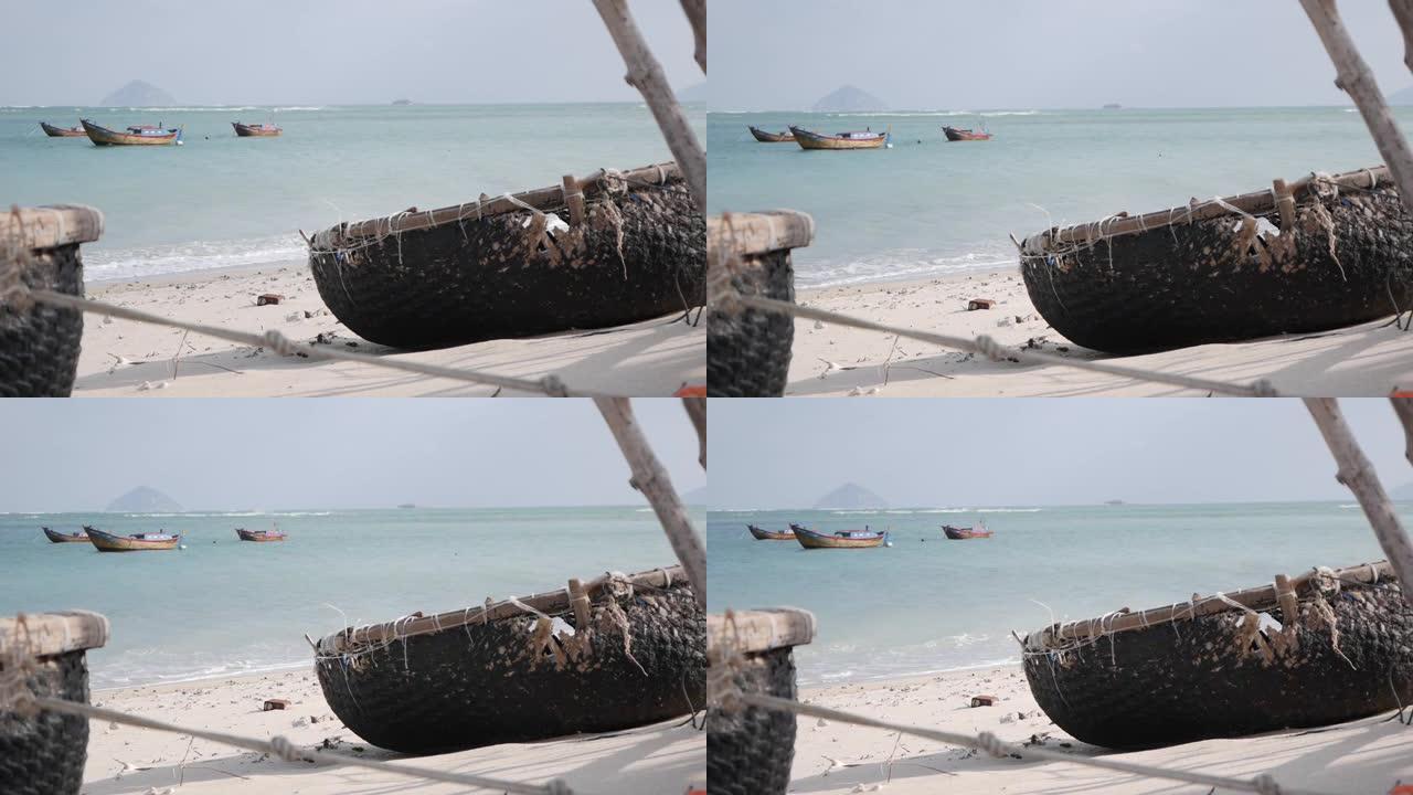 传统的越南圆船在海上背景渔村的沙滩上。渔船和文化象征