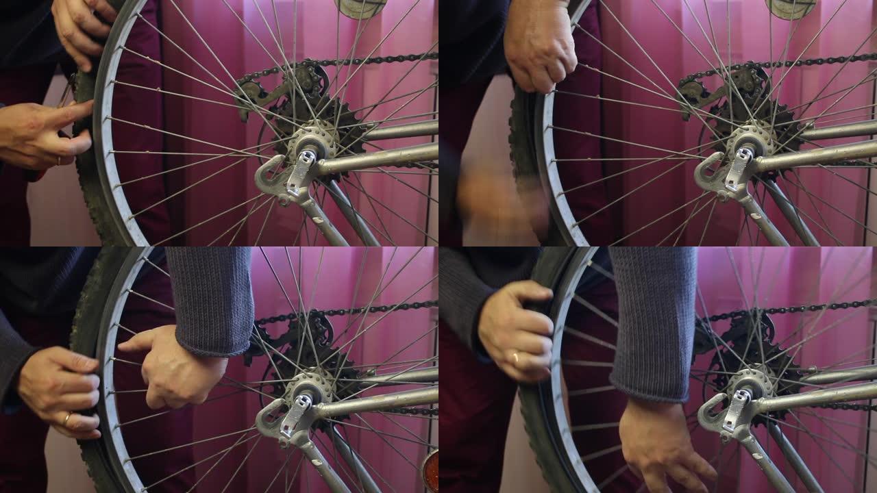 一名男子从自行车车轮上取下轮胎。特写镜头。