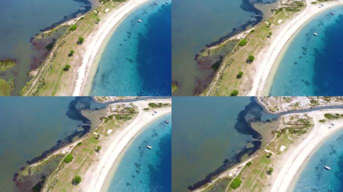 海湾，沙滩和干净的蓝色水在右边，脏水在左边。鸟瞰图
