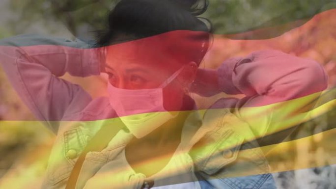 德国国旗对戴口罩的妇女挥舞
