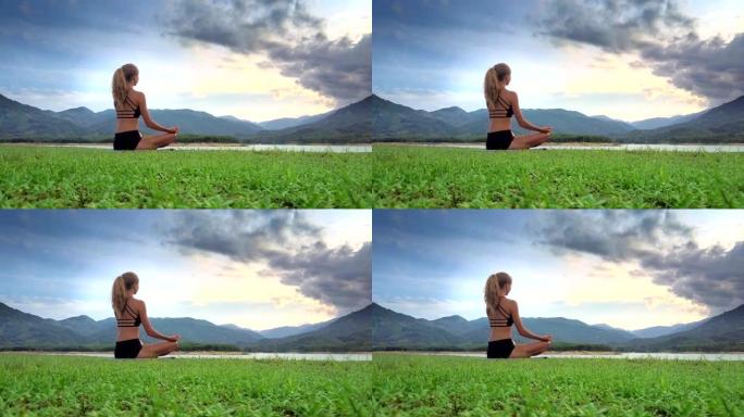 特写女孩在瑜伽中冥想，将莲花摆在丘陵地带
