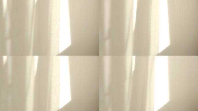 早晨的阳光照亮了房间，阴影背景覆盖。在窗户附近挥舞着白色薄纱
