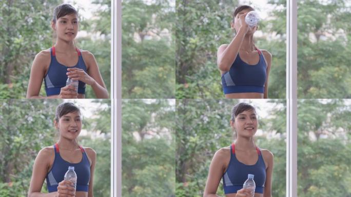 健身女子独自在家进行极限运动后喝水