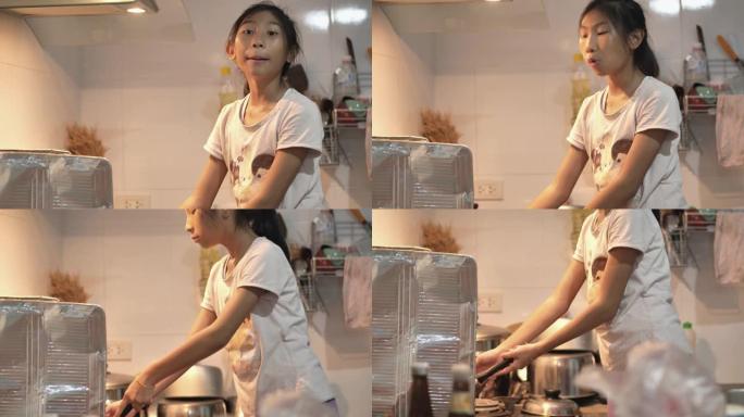 亚洲女孩晚上在家厨房做饭，生活方式理念。