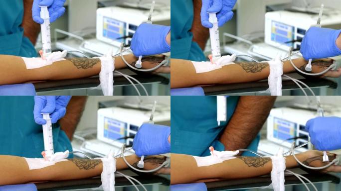 特写，外周静脉导管安装在患者的手臂上。医生或护士戴着医用手套，用注射器通过导管注射药物。手术。麻醉