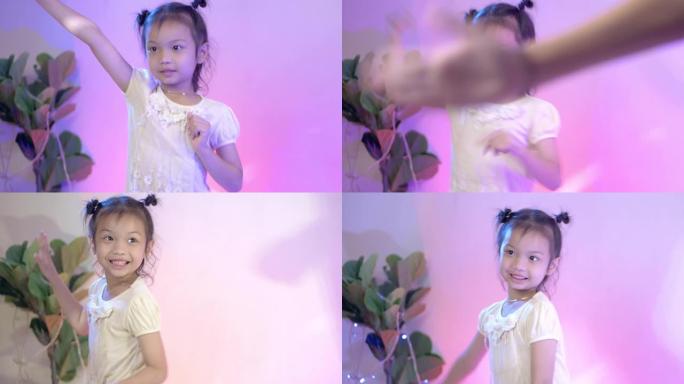 快乐的亚洲儿童在家庭派对上一起跳舞，在家用led灯，生活方式理念。