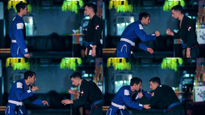 年轻的judokas互相接近并开始战斗。在健身房训练柔道主义者的战斗。