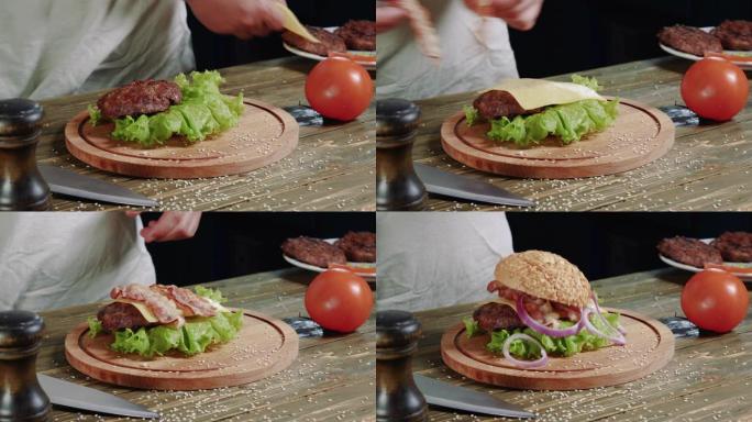 快餐餐厅概念: 美味汉堡特写。烹饪肉汉堡。红洋葱放在肉排和奶酪上。酱汁倒在绿叶生菜上。