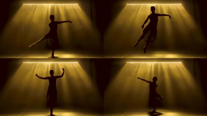 专业芭蕾舞演员在舞台上的聚光灯和烟雾中跳舞芭蕾舞。美丽苗条身材的轮廓。慢动作