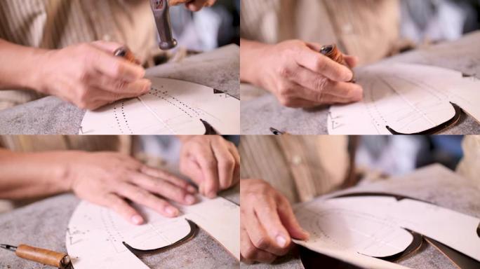 鞋匠在他的车间为新鞋绘制皮革设计。真皮手提包大师在当地车间工作。手工制作的概念。