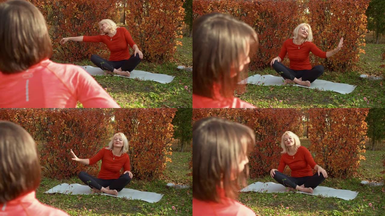 瑜伽女人在秋季公园冥想户外瑜伽训练。放松的女人在公园的地毯上练习瑜伽体式。瑜伽冥想，灵魂和身体平衡。