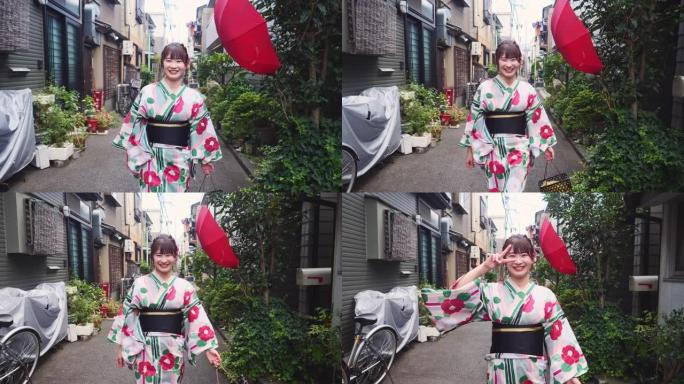 浴衣中的年轻女子走在传统的日本狭窄街道上
