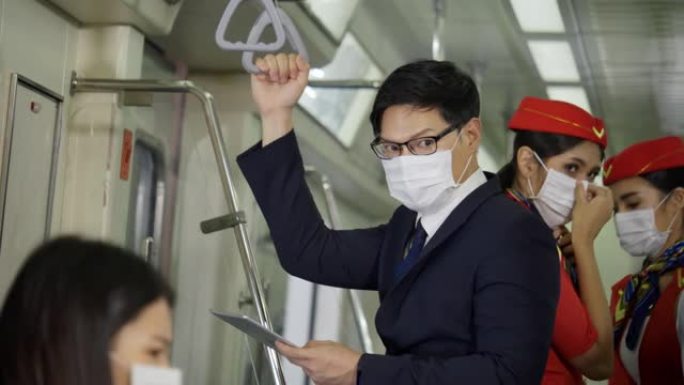 亚洲商人乘坐轻轨上班时戴着面具。预防公共场所的冠状病毒、细菌与人接触。商务人士在高峰时间开会时使用平