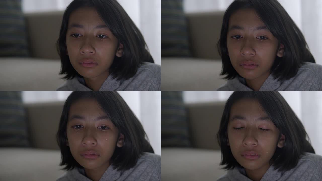 亚洲小女孩哭泣和流泪的特写。亚洲女孩有悲伤的情绪和面部表情