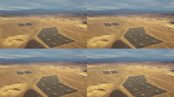 航拍镜头。智利阿塔卡马沙漠的太阳能农场。从空中无人机的角度来看，成千上万的太阳能组件行沿着太阳能光伏