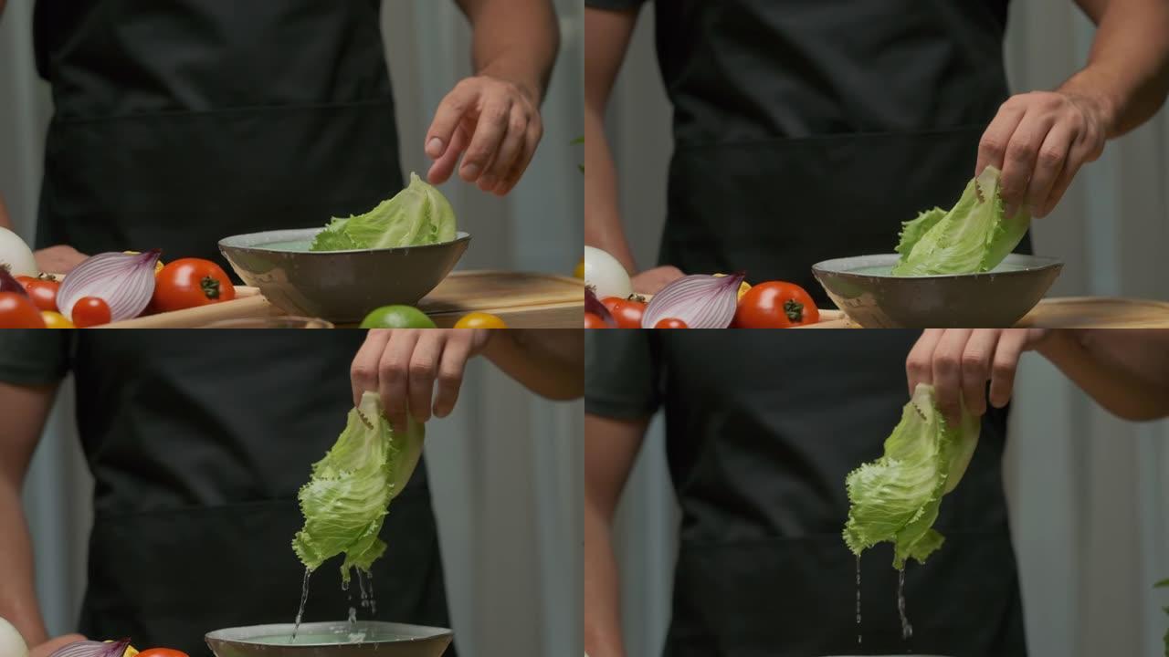 专业厨师洗卷心菜叶。慢动作
