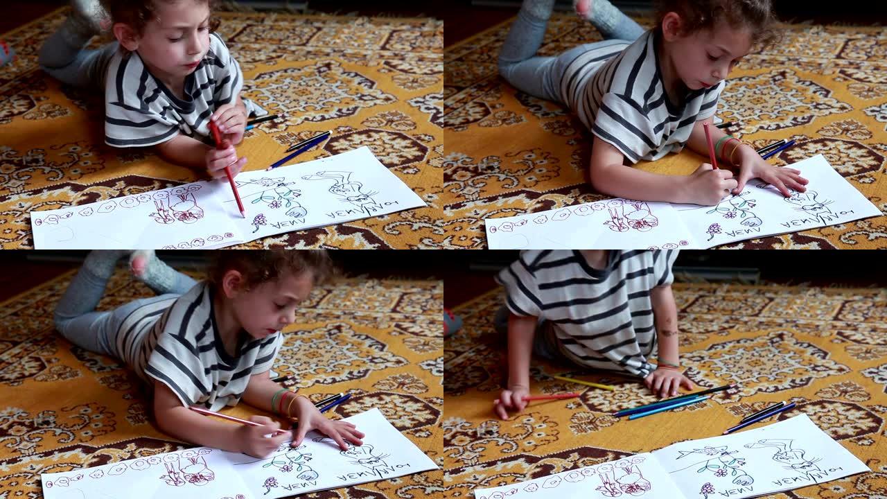 一个小女孩躺在地板上的特写镜头，并在素描本中着色图片