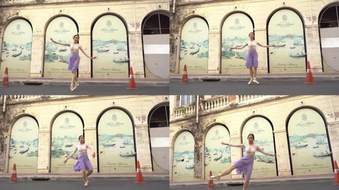 年轻美丽的芭蕾舞演员在街上跳舞