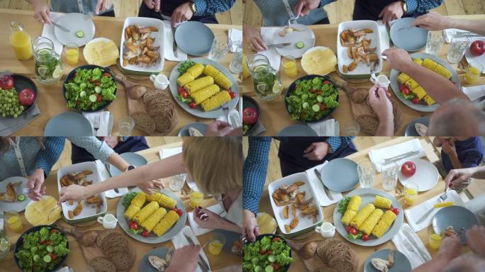 表的俯视图。四个白人朋友吃饭和吃午餐