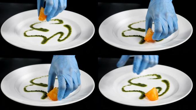 慢动作食品视频概念。厨师把切片柠檬放在盘子里的特写镜头。沙拉准备。美食概念。高清