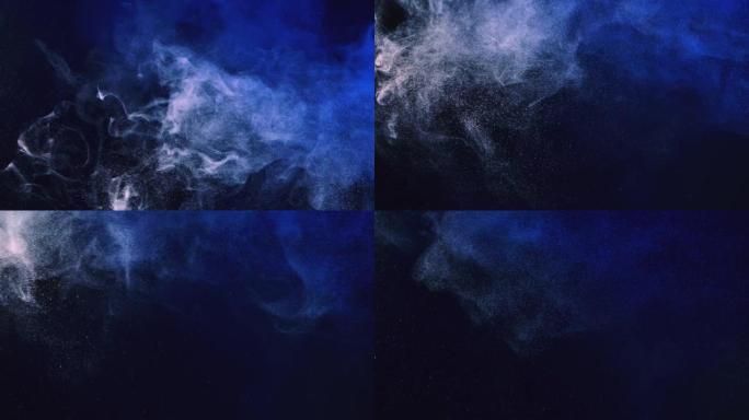 用蓝光在黑色背景上散布细小的白色尘埃。圆形灰尘颗粒随着烟雾漂浮在空气中。特写。慢动作
