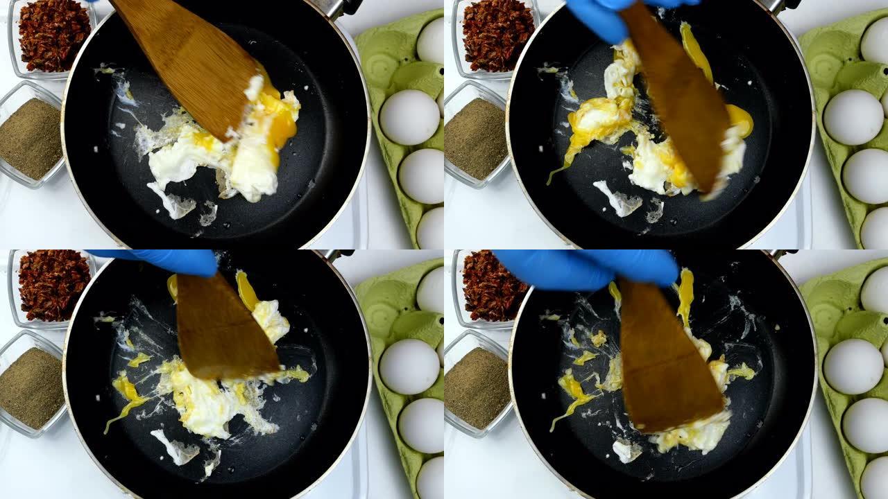 用无能的厨师在厨房锅里煮煎蛋。混合食物。