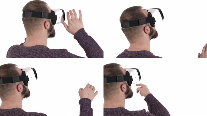 一个戴着虚拟现实眼镜的年轻人的后视图-通过虚拟现实界面上网。