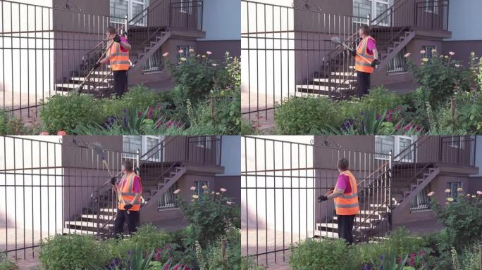 街上的清洁女工清除垃圾。院子里的清洁度和秩序取决于检疫期间的看门人。