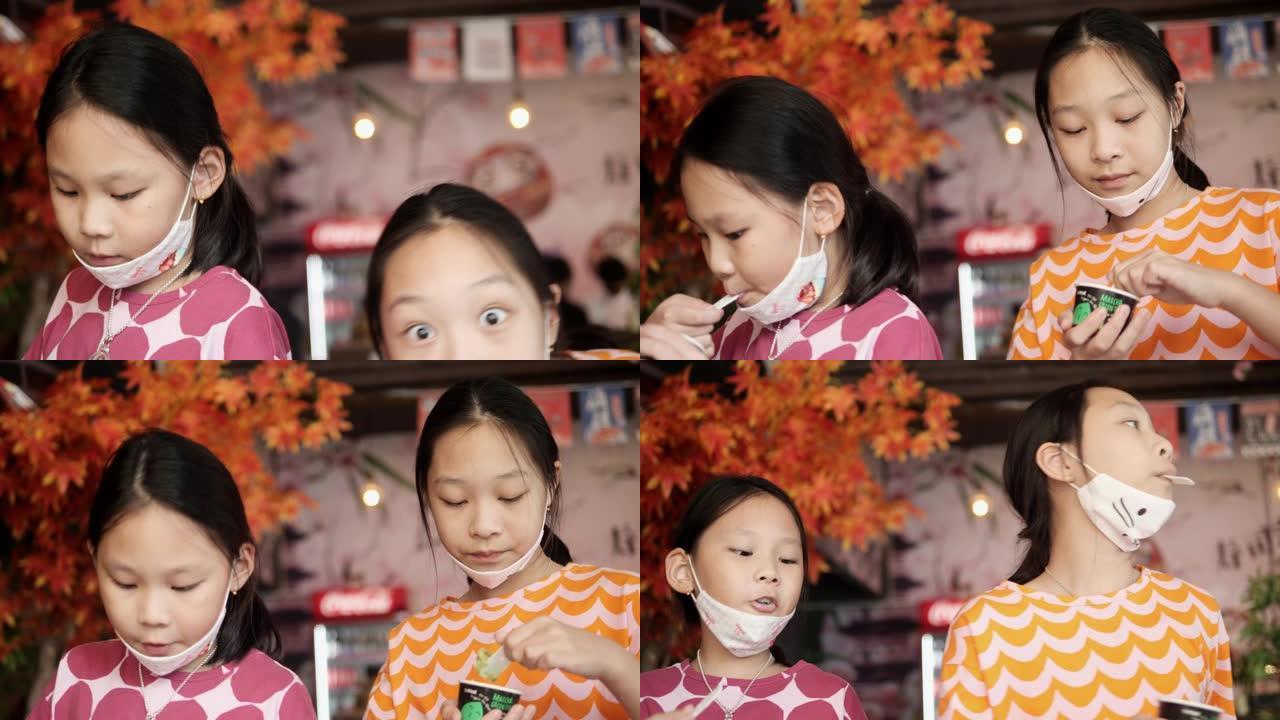 快乐的亚洲女孩在日本餐厅吃冰淇淋，有家庭生活方式的概念。
