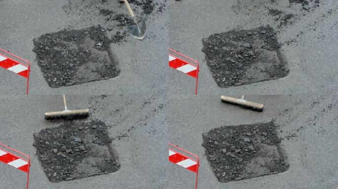 用铁锹浇铸水泥溶液的道路被毁部分的特写俯视图，工人在道路上安装混凝土，翻新街道路面。施工现场工作流程