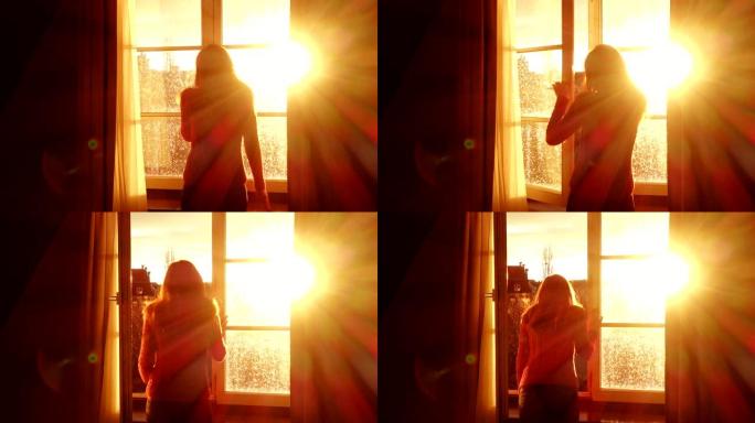 女孩打开窗户，看着橙色日落阳光的夜晚城市