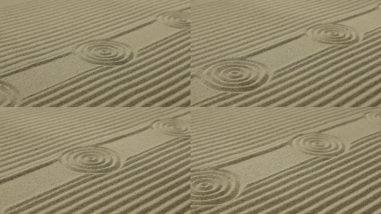 沙滩上的圆圈和线条。沙子的质地。滑块镜头。
