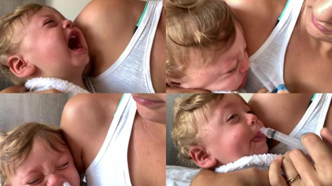 母亲去除婴儿粘液。蹒跚学步的孩子鼻子充血。婴儿的抱怨和哭泣