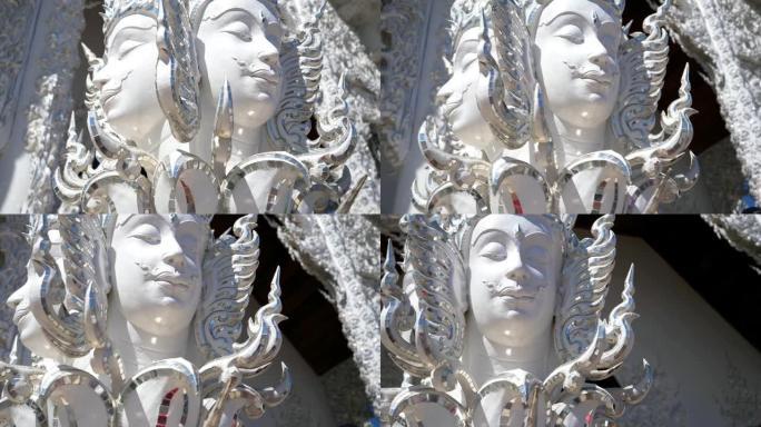 白色神庙入口雕像脸的特写