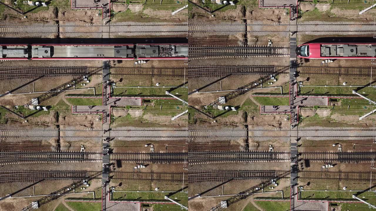 城市中一个危险的铁路道口的鸟瞰图。人们走在铁轨上