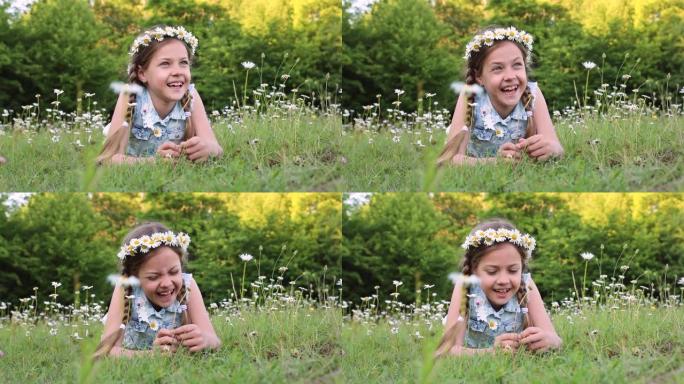穿着夏装的可爱的小女孩躺在草地上。小女孩和雏菊