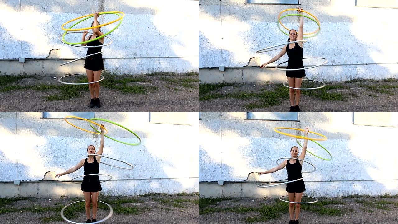街头艺人练习呼啦圈旋转技巧。一位迷人的女性，马戏团表演者，在街上旋转呼啦圈，提高了她的技能。