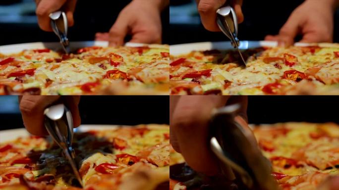 特写人员将意大利披萨切成小块
