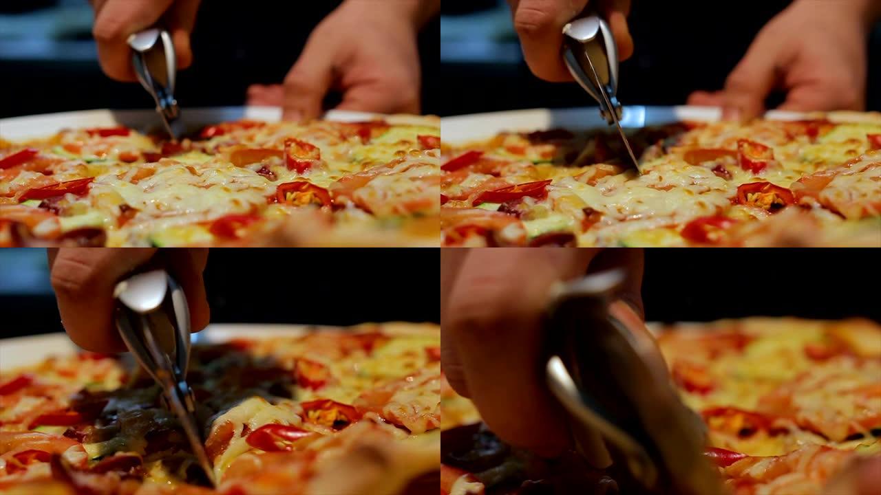 特写人员将意大利披萨切成小块
