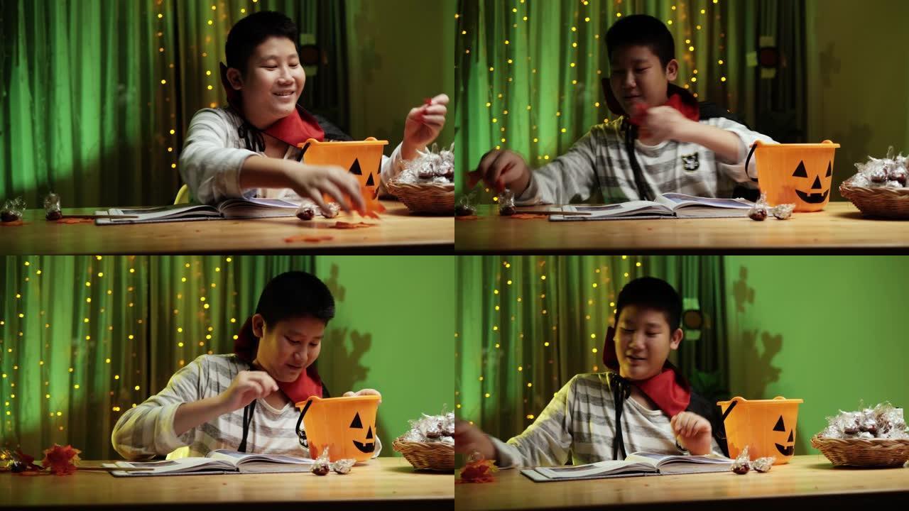 亚洲男孩用魔杖在晚上在家玩万圣节概念。