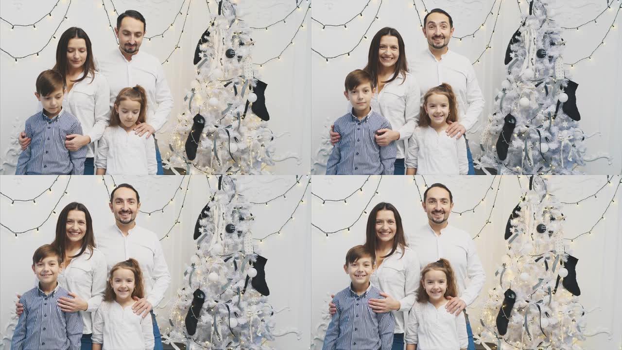 幸福的家庭成员: 圣诞树附近白色背景上的母亲，父亲，儿子，女儿。