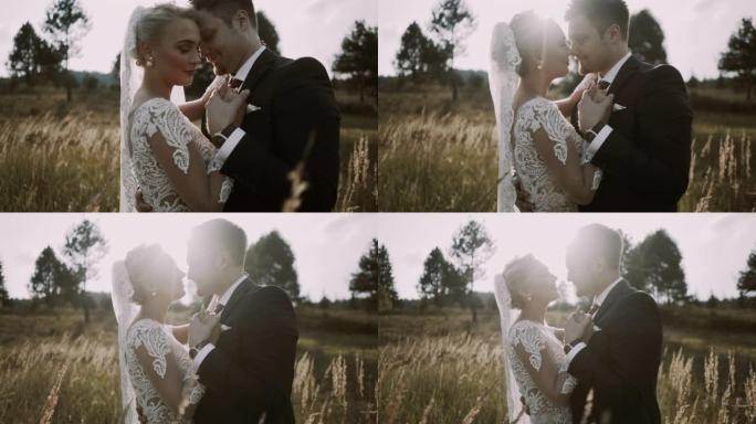 非常美丽的新娘和新郎在森林里度过浪漫时光和接吻的特写镜头。